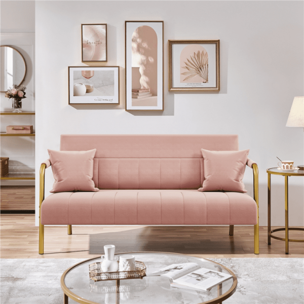 Close-up of pink fabric and cushions on small sofa